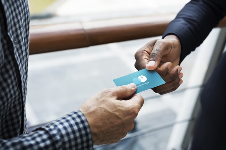 person-handing-over-business-card